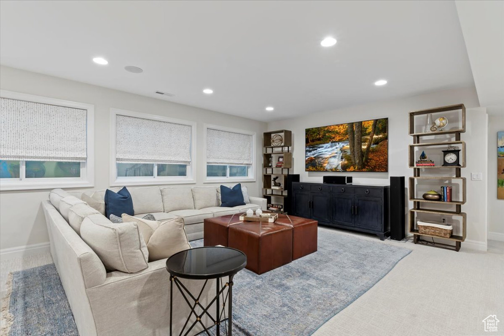 Carpeted living room with recessed lighting and baseboards
