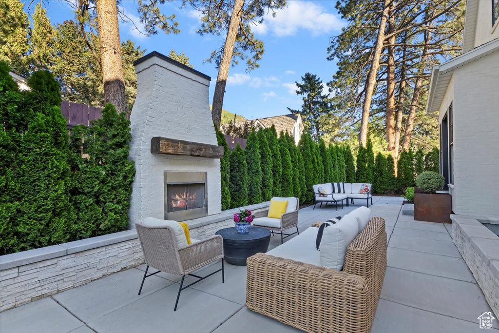 View of patio / terrace with an outdoor living space with a fireplace