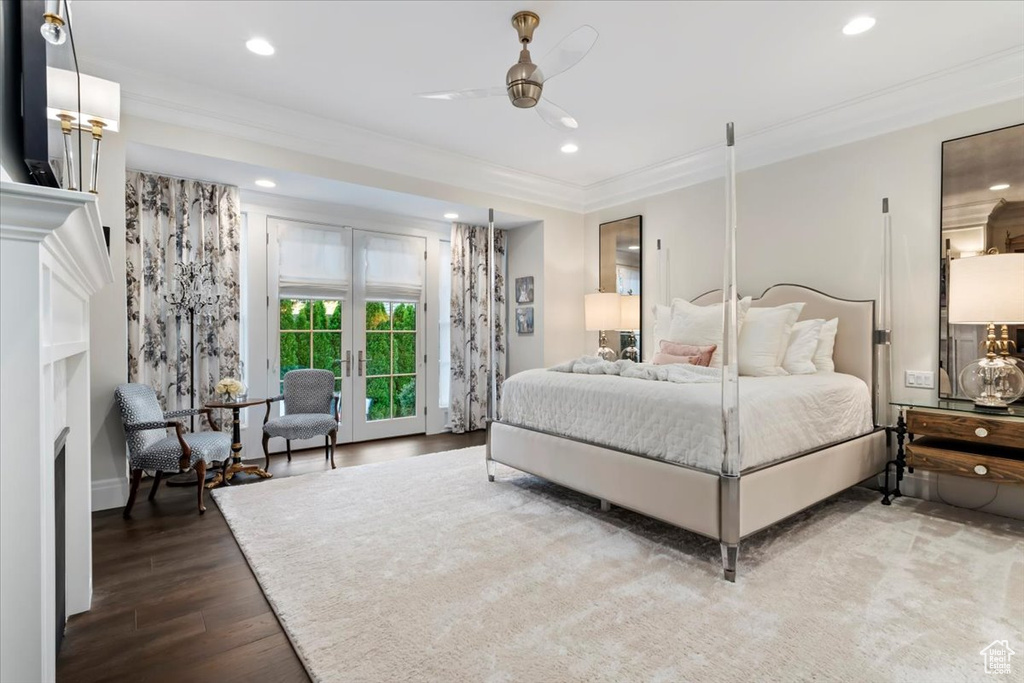 Bedroom featuring access to outside, ornamental molding, wood finished floors, recessed lighting, and a fireplace