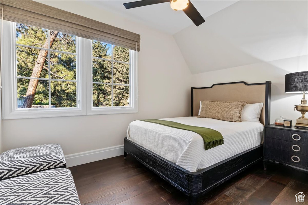 Bedroom with baseboards, wood finished floors, lofted ceiling, and a ceiling fan