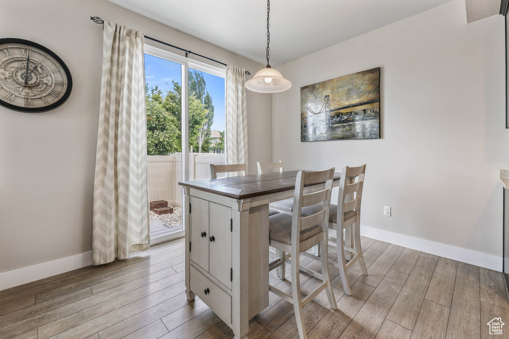 Dining area featuring light wood-style floors and baseboards