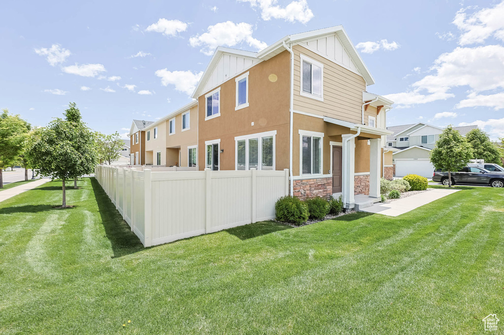 View of side of home featuring board and batten siding, stone siding, and stucco siding