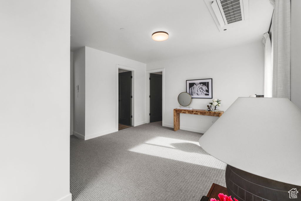 Corridor featuring carpet flooring and baseboards
