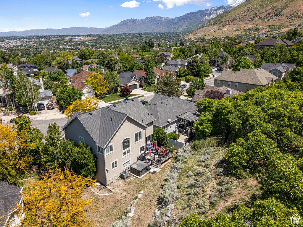 Aerial perspective of suburban area featuring a mountainous background