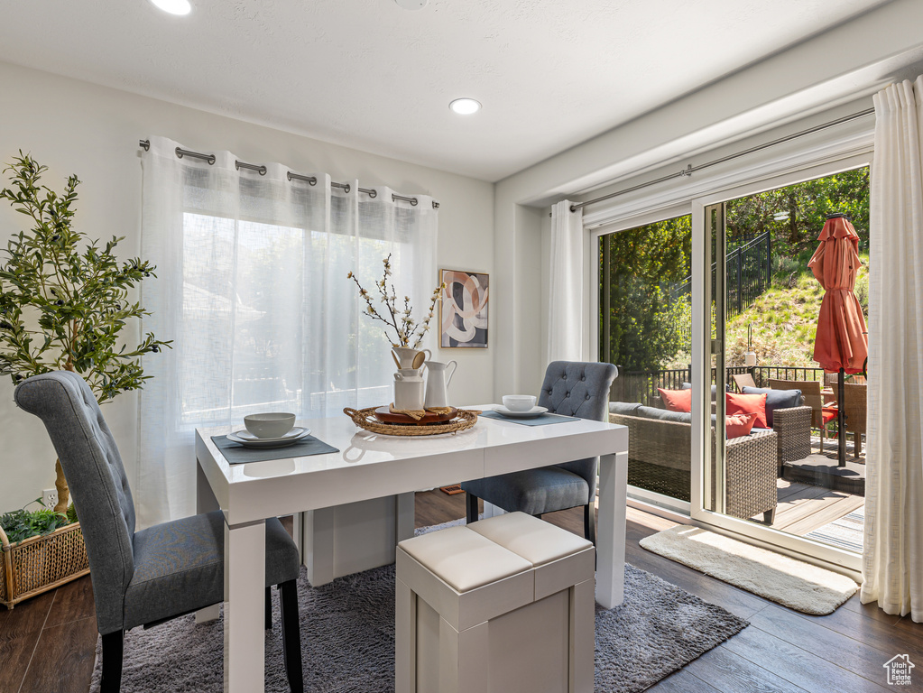 Dining space featuring dark wood-style floors and recessed lighting