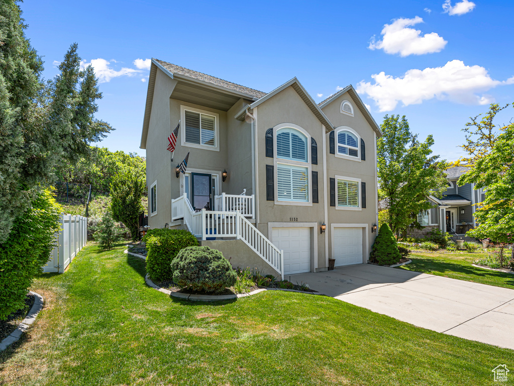 Multi unit property with an attached garage, stucco siding, and driveway