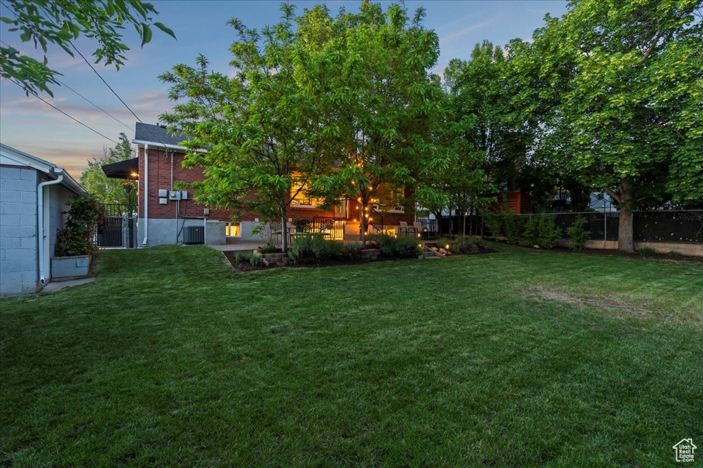 Yard at dusk with central AC unit