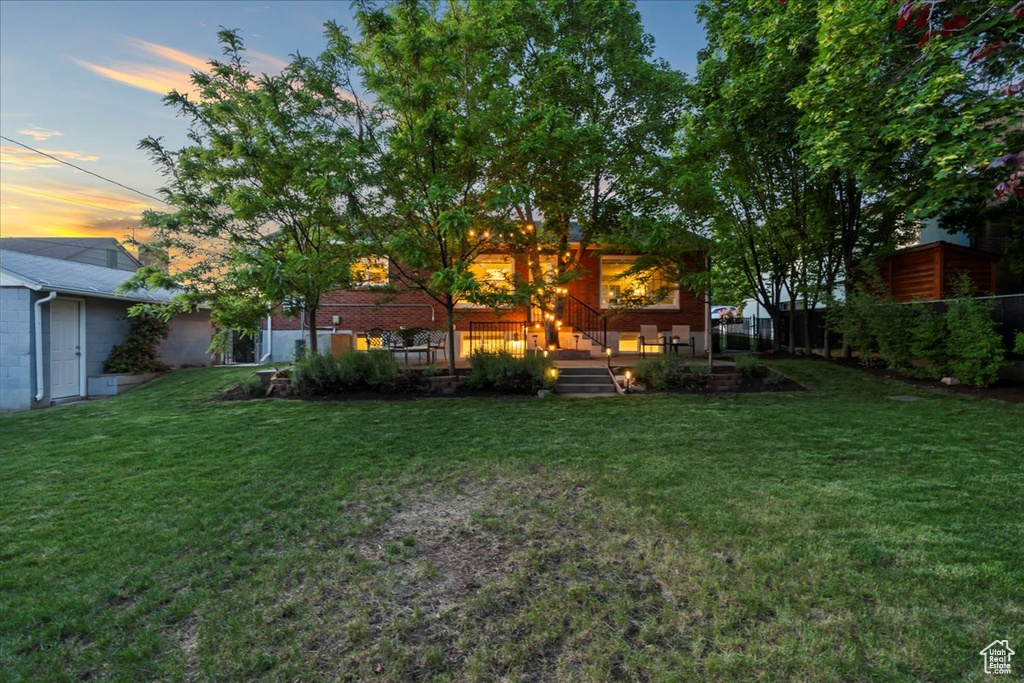 Back of house featuring a lawn
