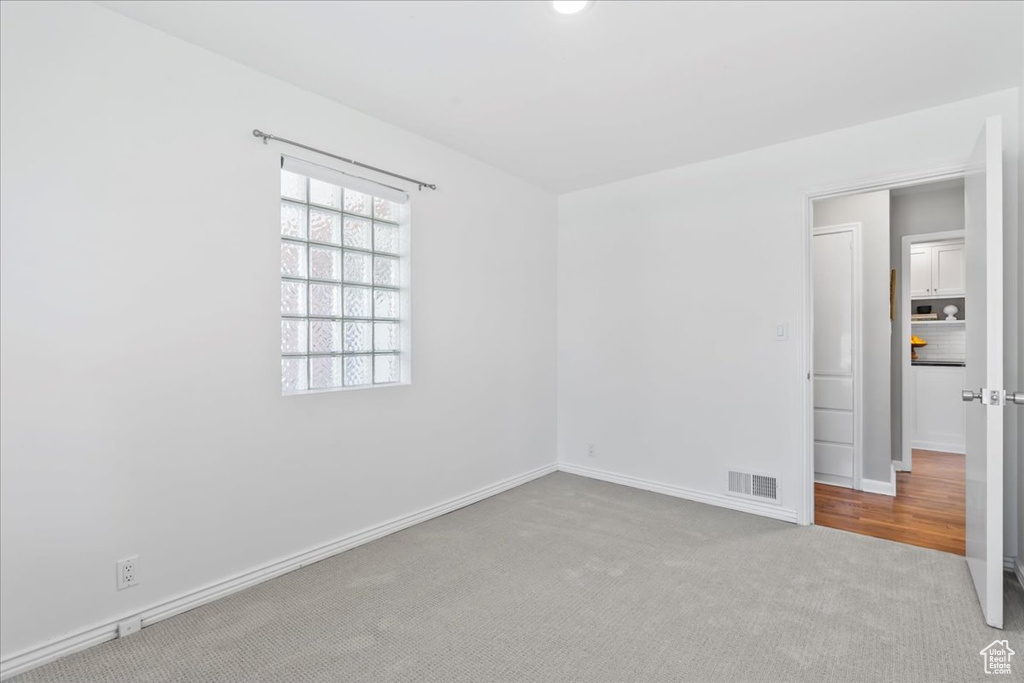 Empty room with carpet and baseboards