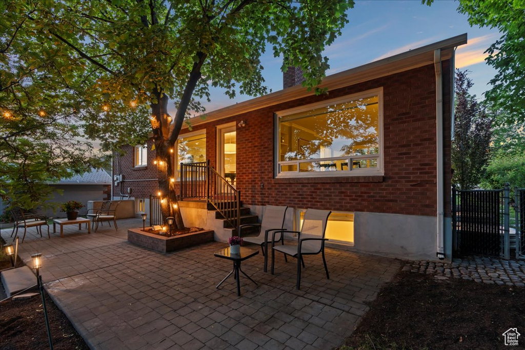 View of patio with an outdoor fire pit