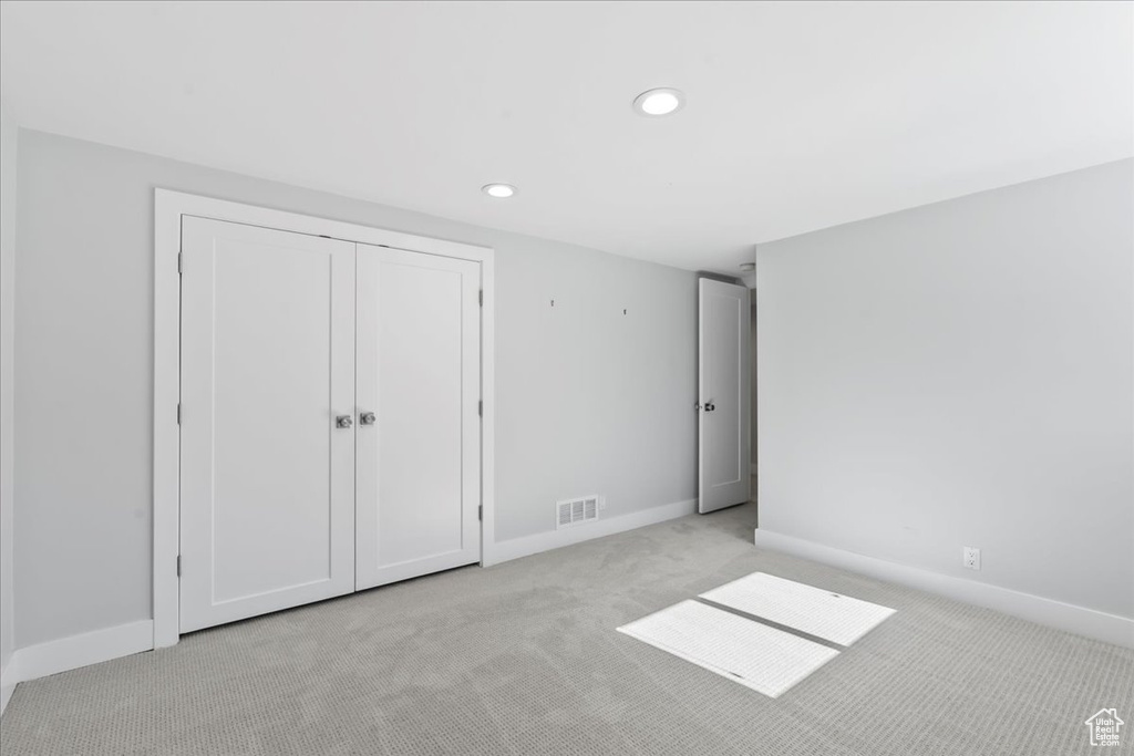 Unfurnished bedroom with carpet flooring, recessed lighting, baseboards, and a closet