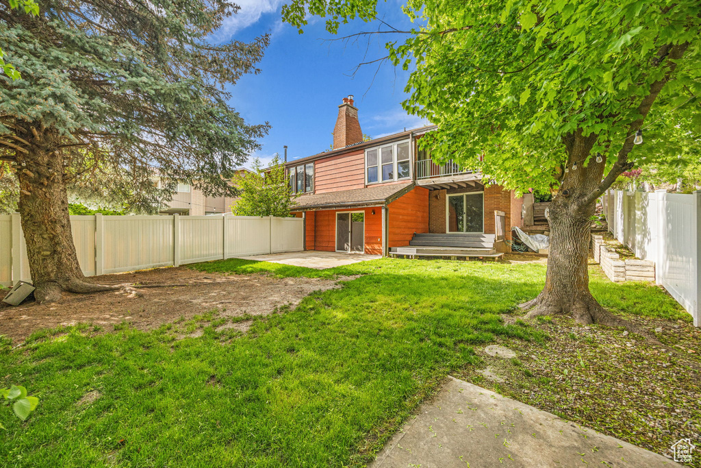Back of property featuring a patio and a chimney