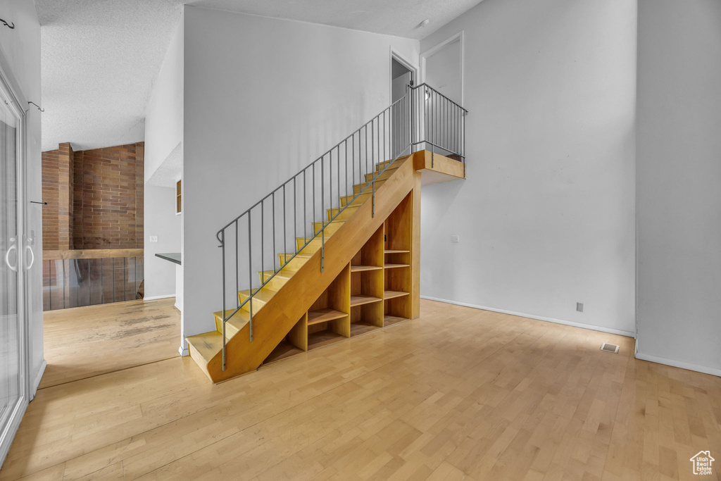 Stairs featuring wood finished floors and baseboards