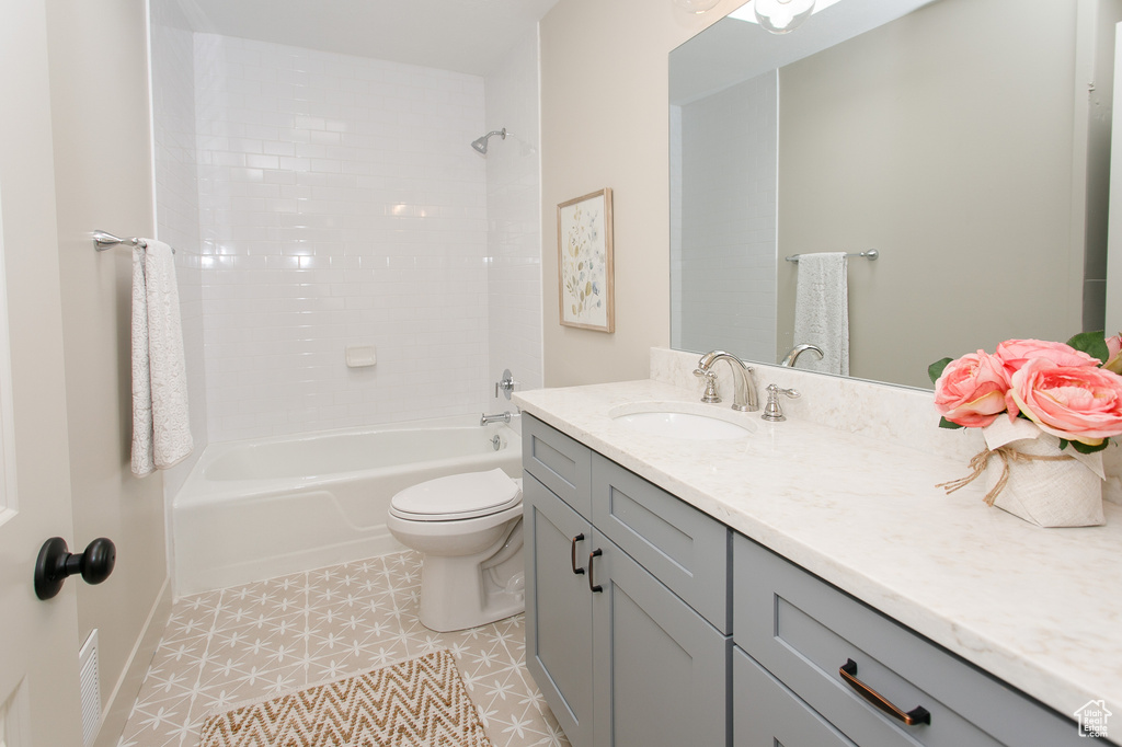 Bathroom with vanity, toilet, and shower / washtub combination