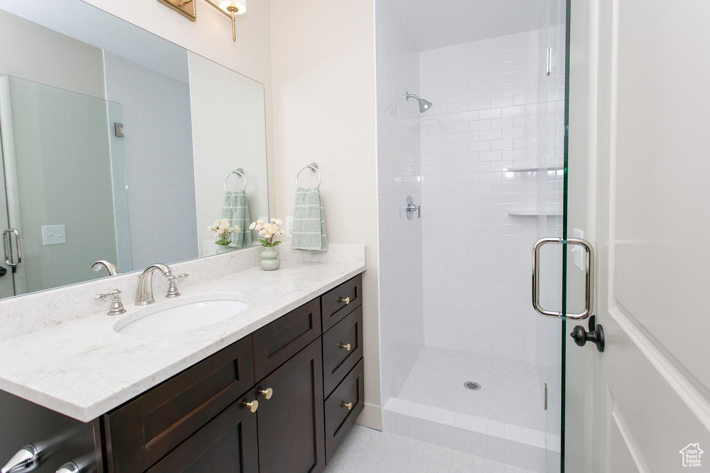 Bathroom with vanity and a shower stall