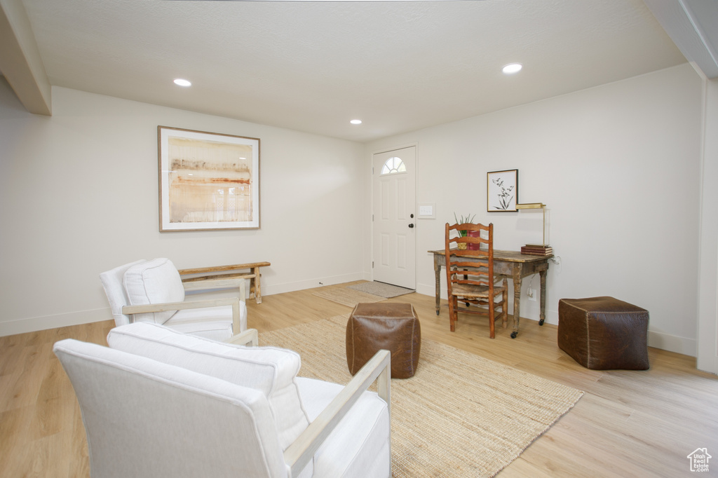 Living room featuring light wood-type flooring, recessed lighting, and baseboards