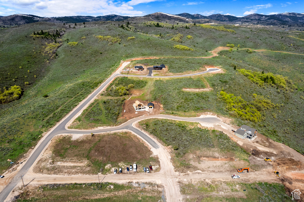 Aerial view of property and surrounding area with a mountain backdrop