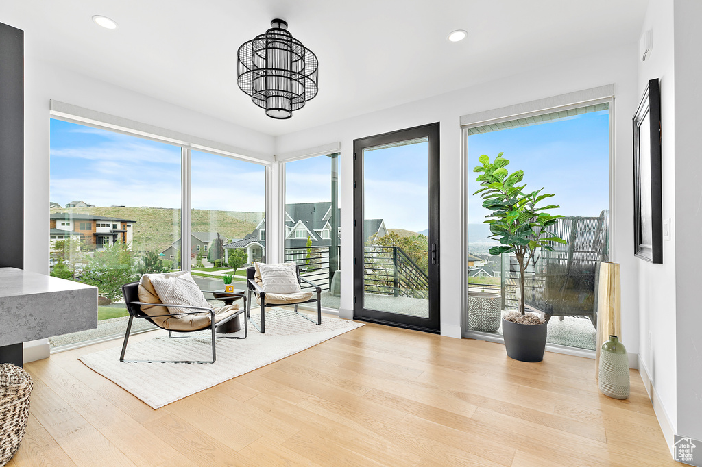 Sitting room with wood finished floors and recessed lighting