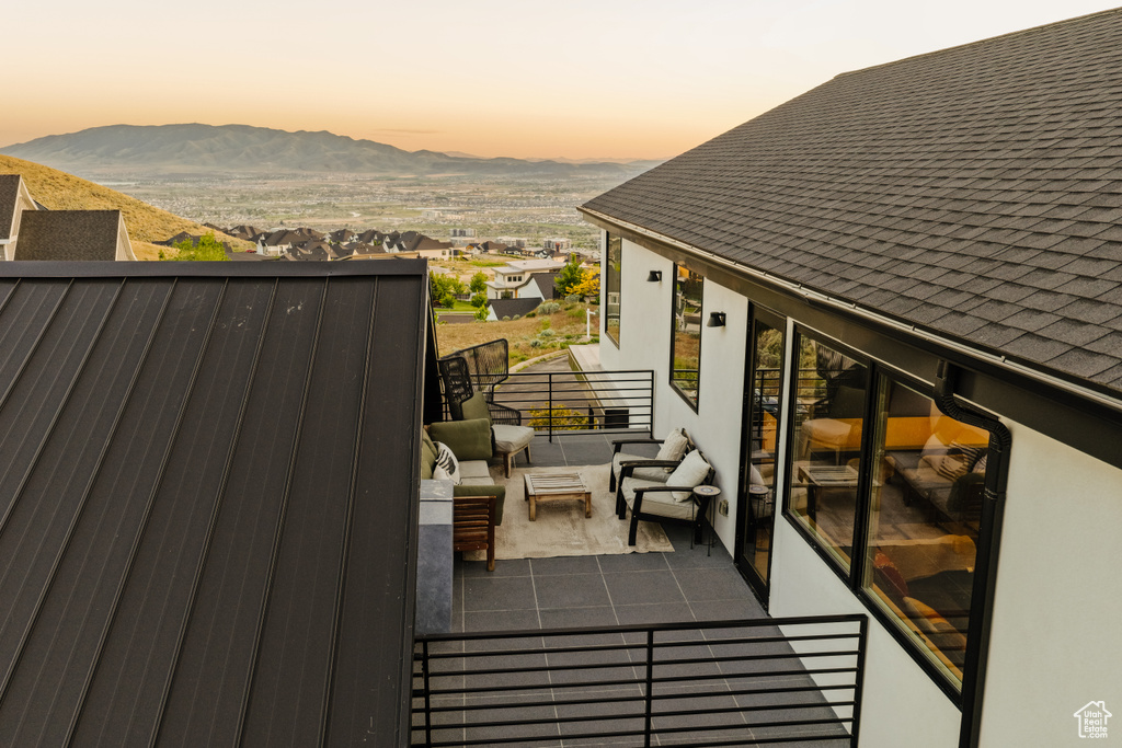 Balcony at dusk featuring a mountain view