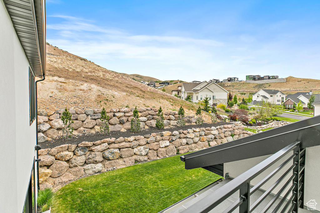 View of yard with a balcony and a residential view