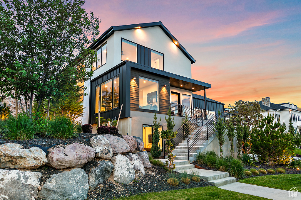 Contemporary home featuring stairway and stucco siding