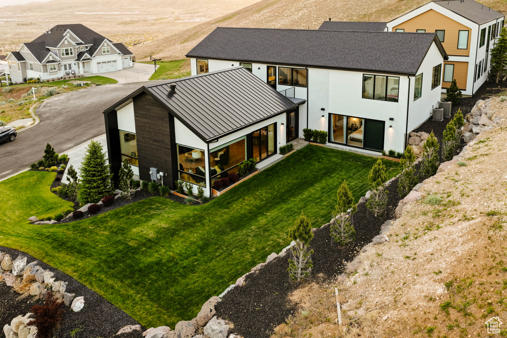 Aerial view of property and surrounding area featuring mountains
