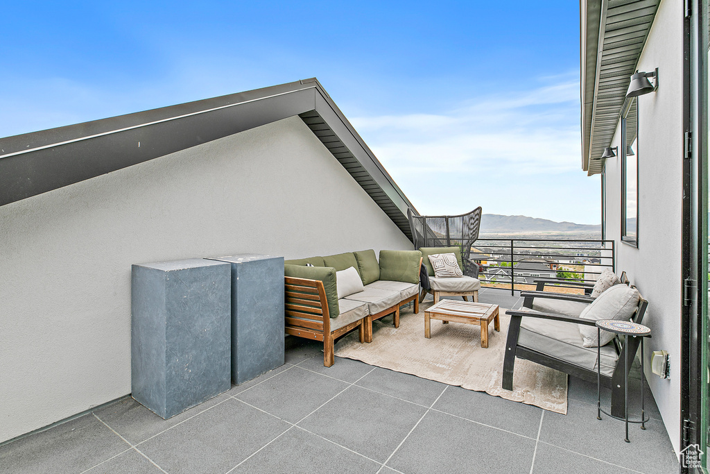View of patio with a balcony, a mountain view, and an outdoor living space