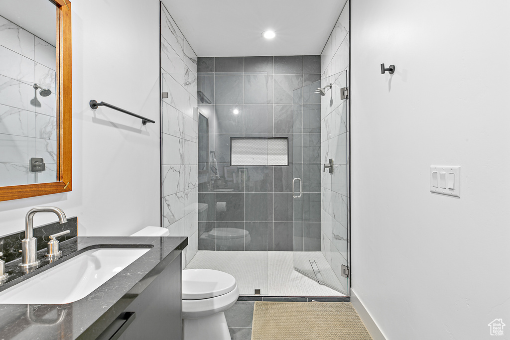 Full bathroom with toilet, a stall shower, vanity, recessed lighting, and tile patterned floors