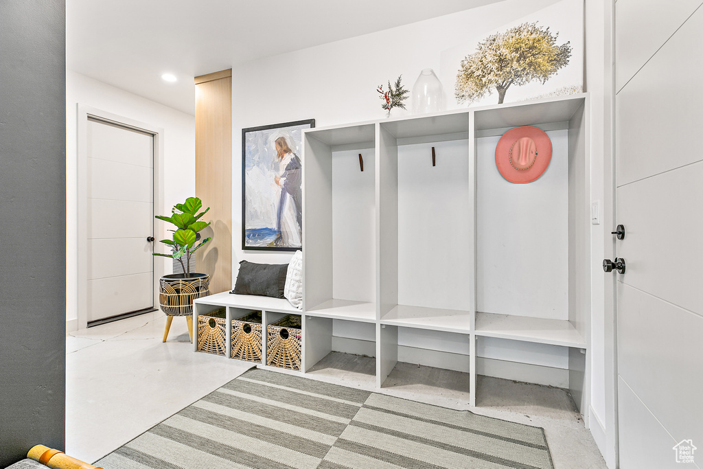 Mudroom featuring finished concrete flooring and recessed lighting