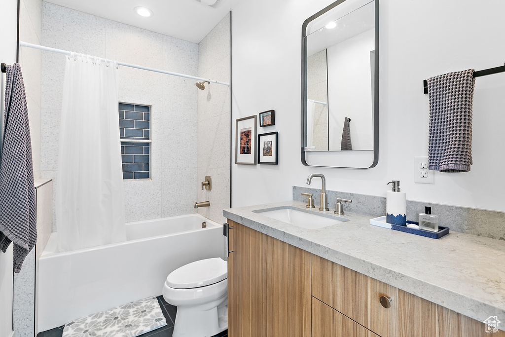 Bathroom with toilet, shower / tub combo with curtain, vanity, and recessed lighting