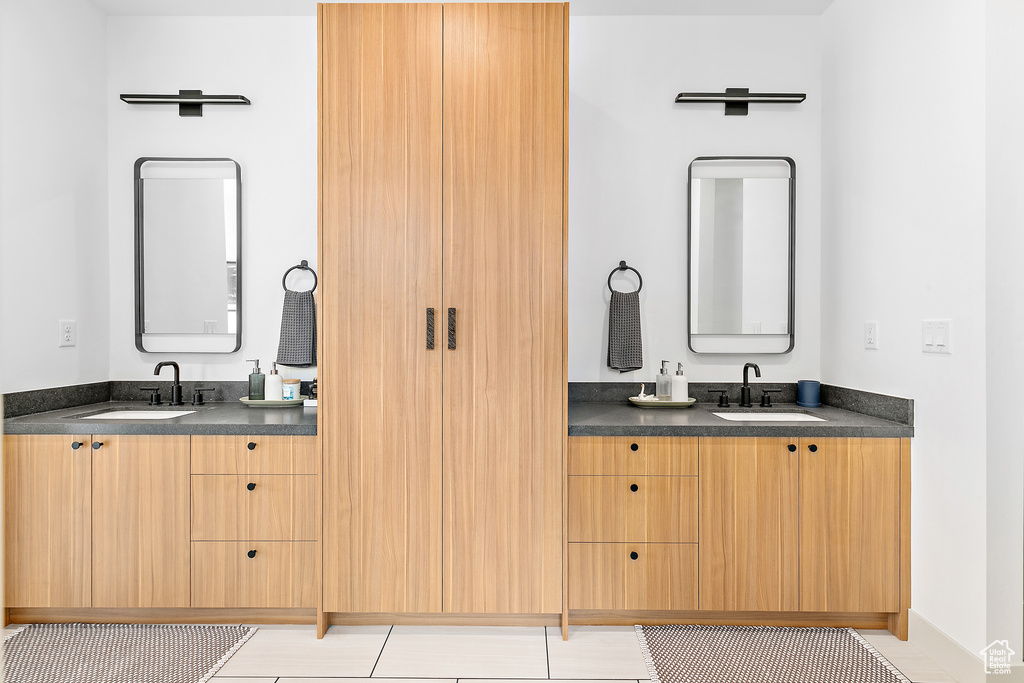 Full bath featuring vanity and tile patterned floors