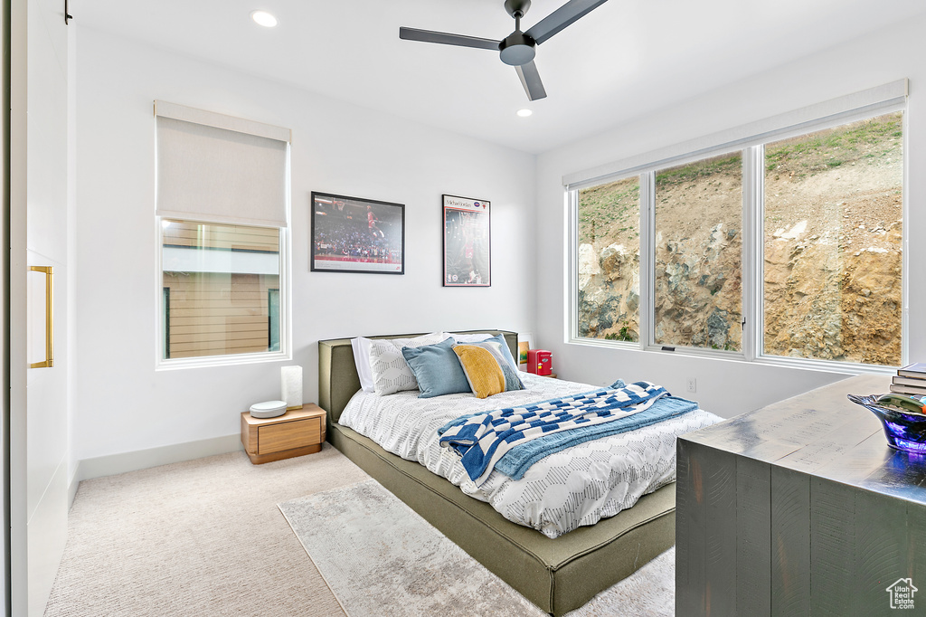 Carpeted bedroom featuring baseboards, recessed lighting, and ceiling fan