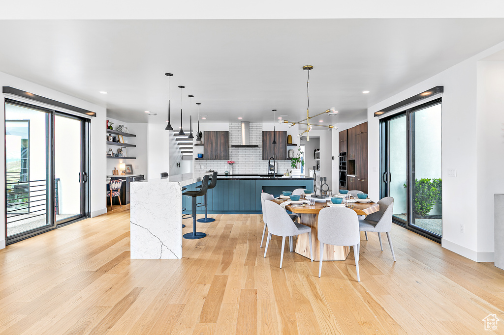 Dining room with plenty of natural light, light wood-style floors, and recessed lighting