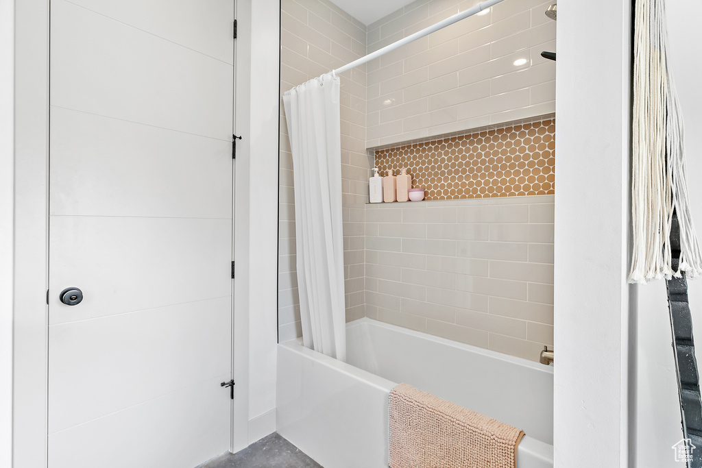 Bathroom featuring shower / bath combination with curtain