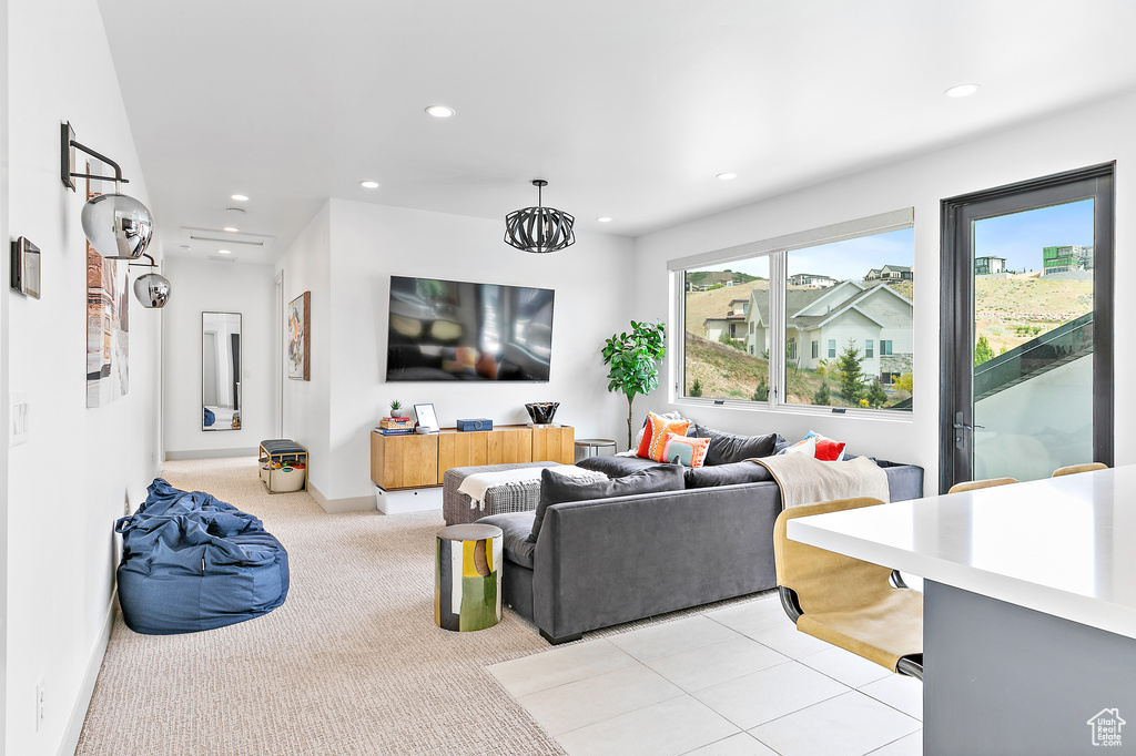 Living room with recessed lighting, light colored carpet, and baseboards