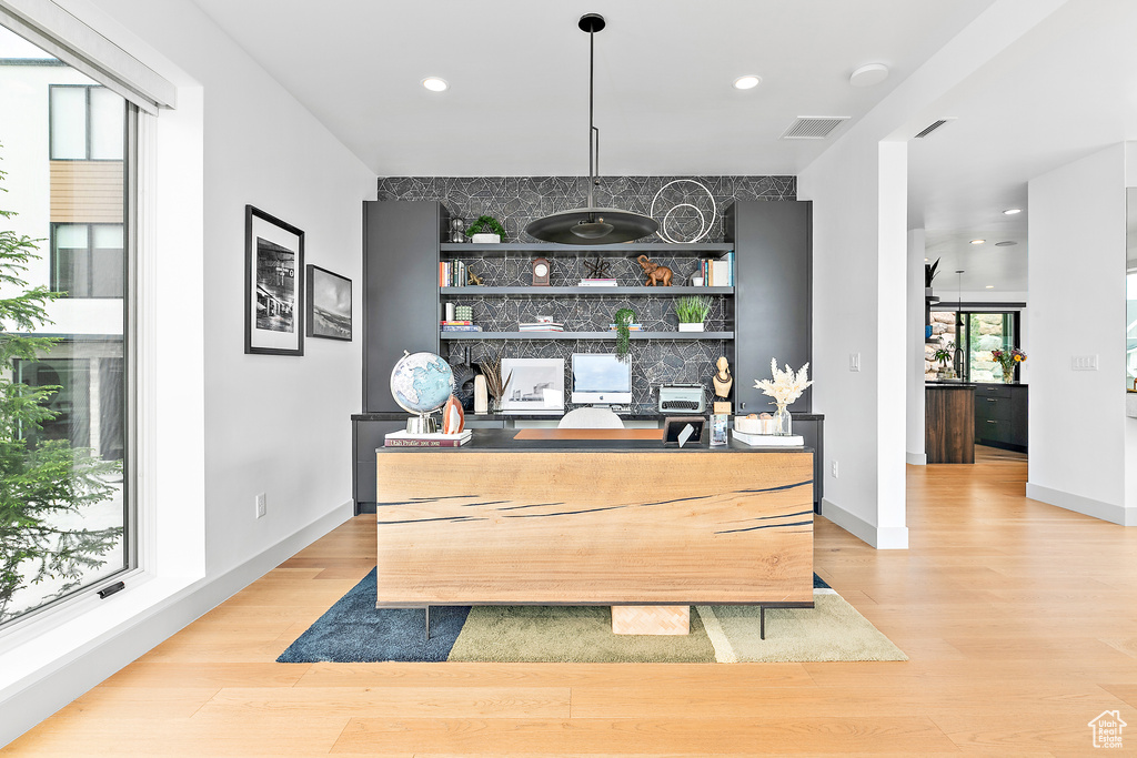 Bar with light wood-style flooring, recessed lighting, baseboards, and decorative light fixtures