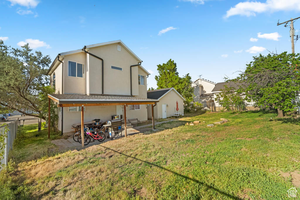 Rear view of house featuring a patio and stucco siding