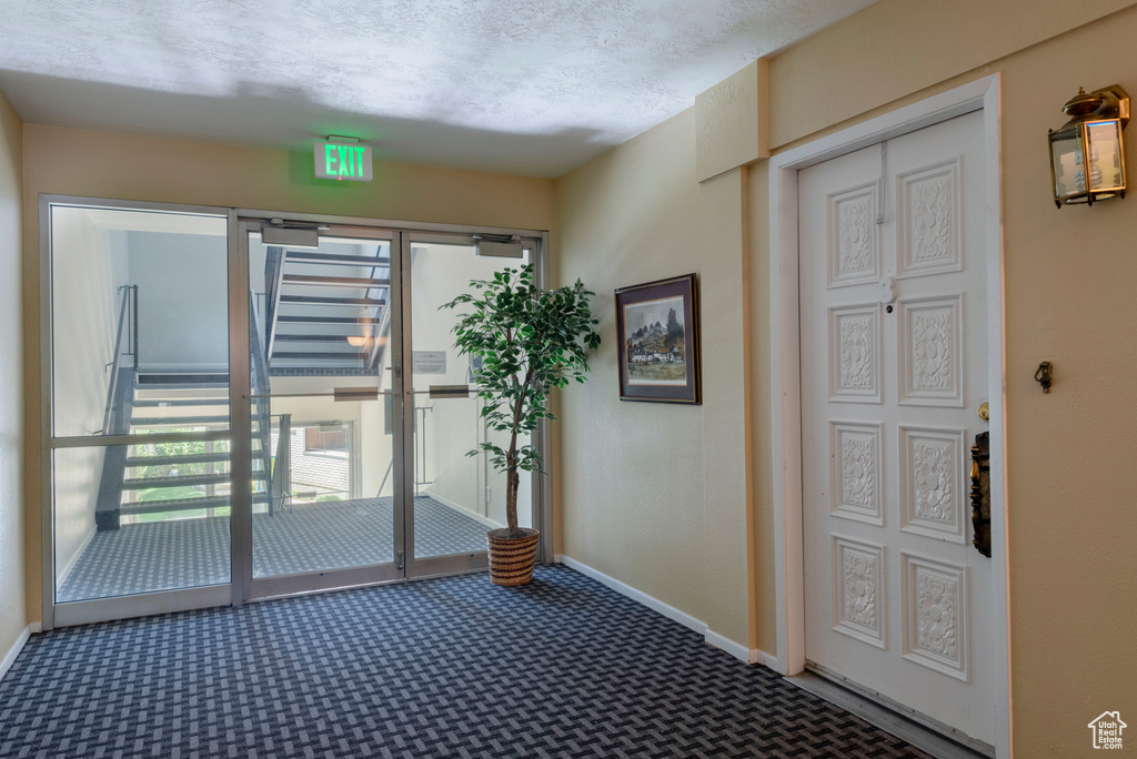 Spare room featuring carpet flooring and baseboards