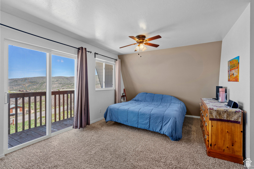 Bedroom with carpet, baseboards, and access to outside