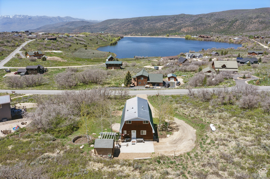 View of subject property featuring a water and mountain view