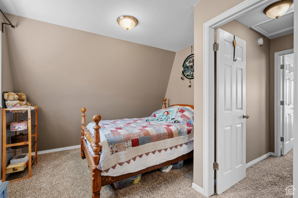Carpeted bedroom featuring baseboards and attic access