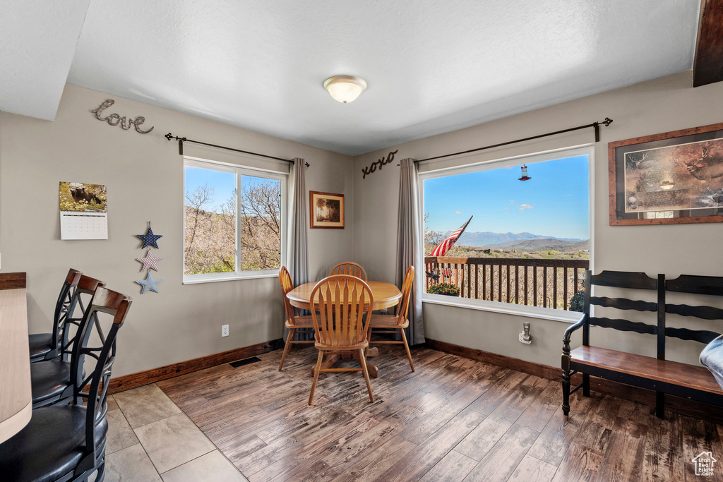 Dining room featuring baseboards, wood finished floors, and a mountain view