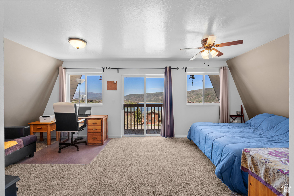 Carpeted bedroom with access to exterior, an office area, baseboards, and a ceiling fan