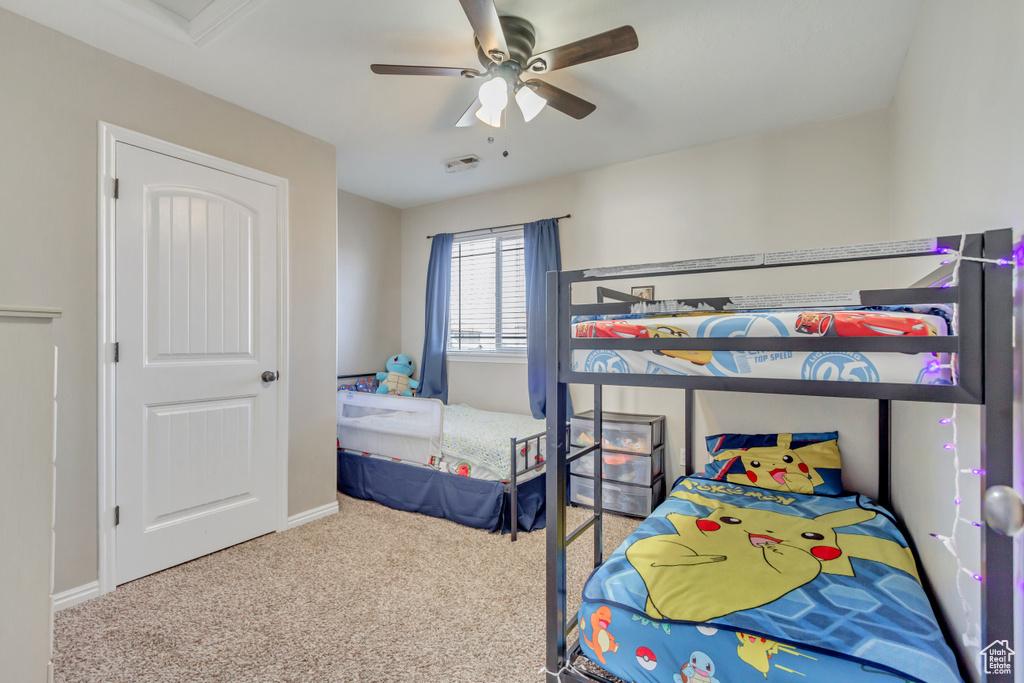 Carpeted bedroom with baseboards and ceiling fan