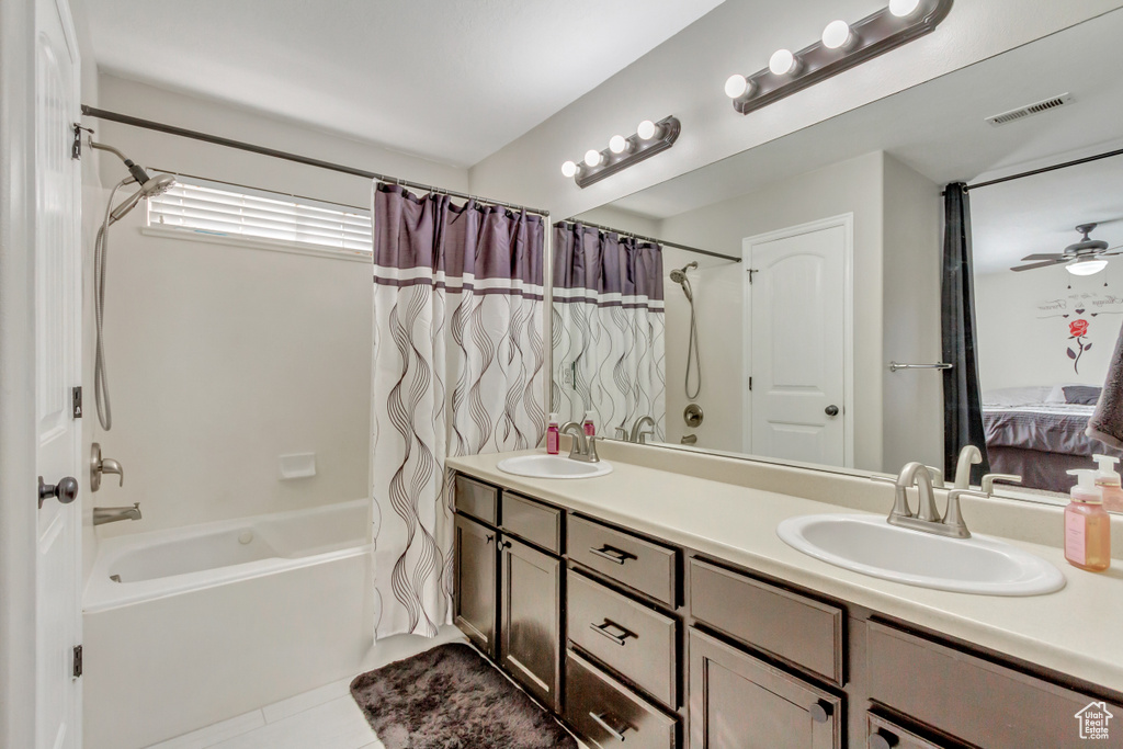 Ensuite bathroom featuring shower / tub combo, double vanity, and tile patterned flooring