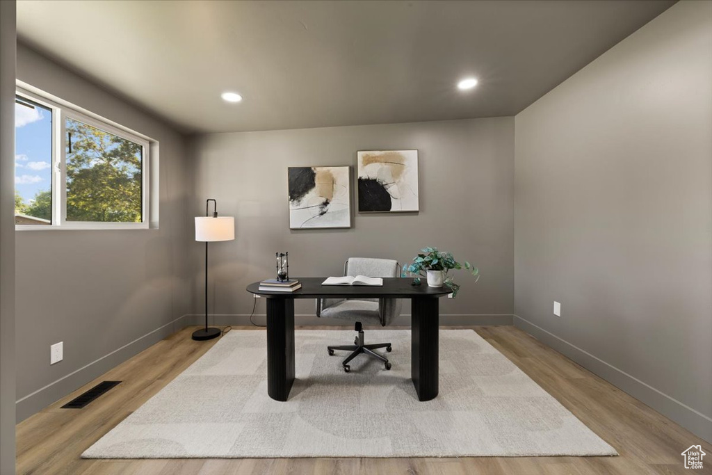 Home office with light wood-style floors, baseboards, and recessed lighting