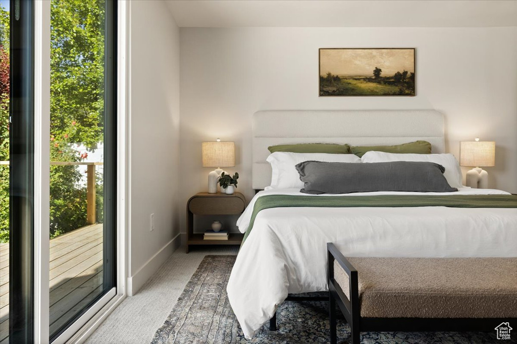 Bedroom featuring carpet floors, access to outside, and baseboards
