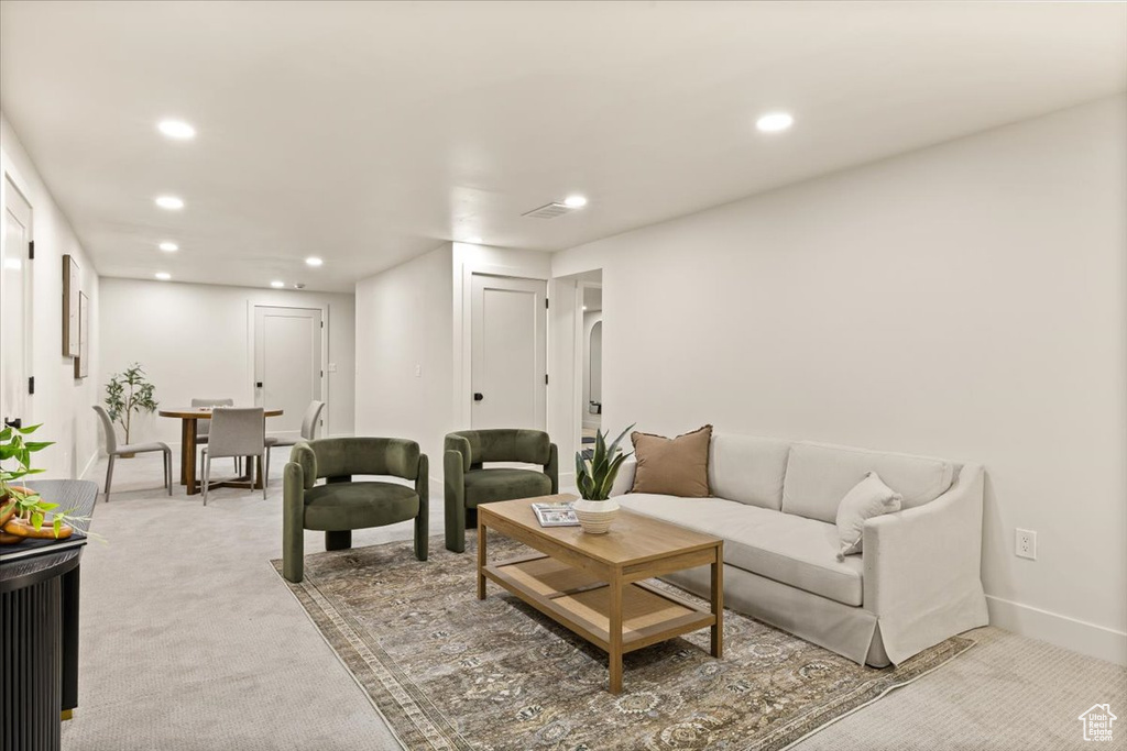 Living room featuring recessed lighting, light colored carpet, and baseboards