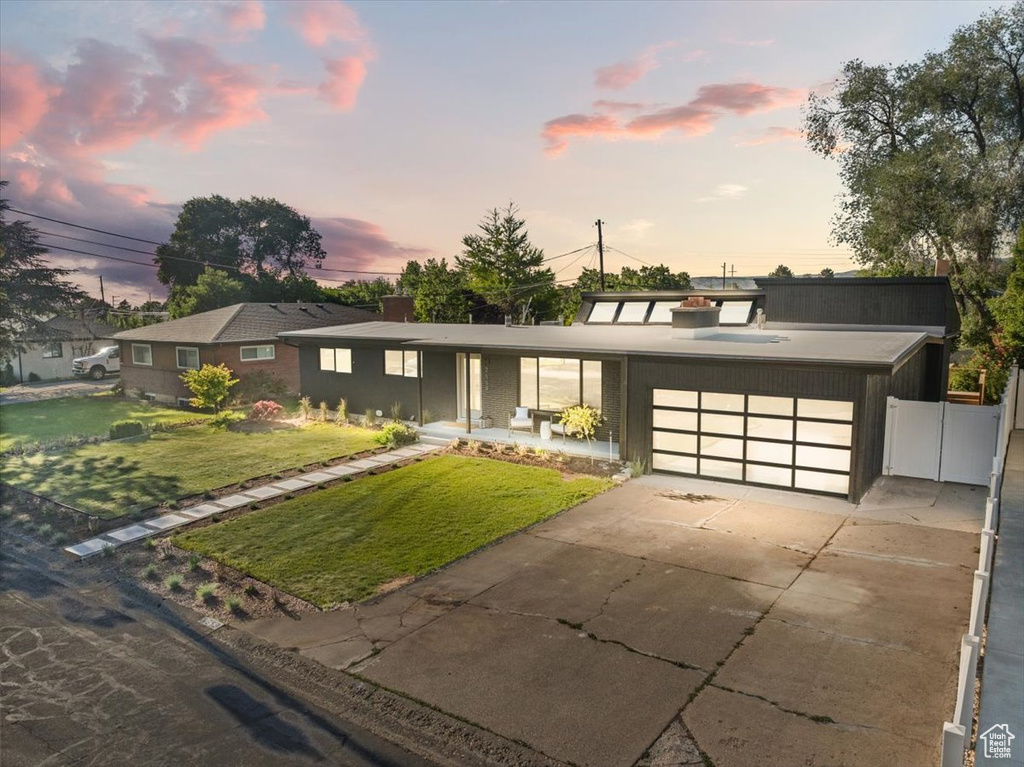 View of front of house featuring a garage and concrete driveway