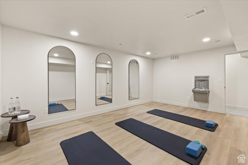 Workout room with recessed lighting, wood finished floors, and baseboards